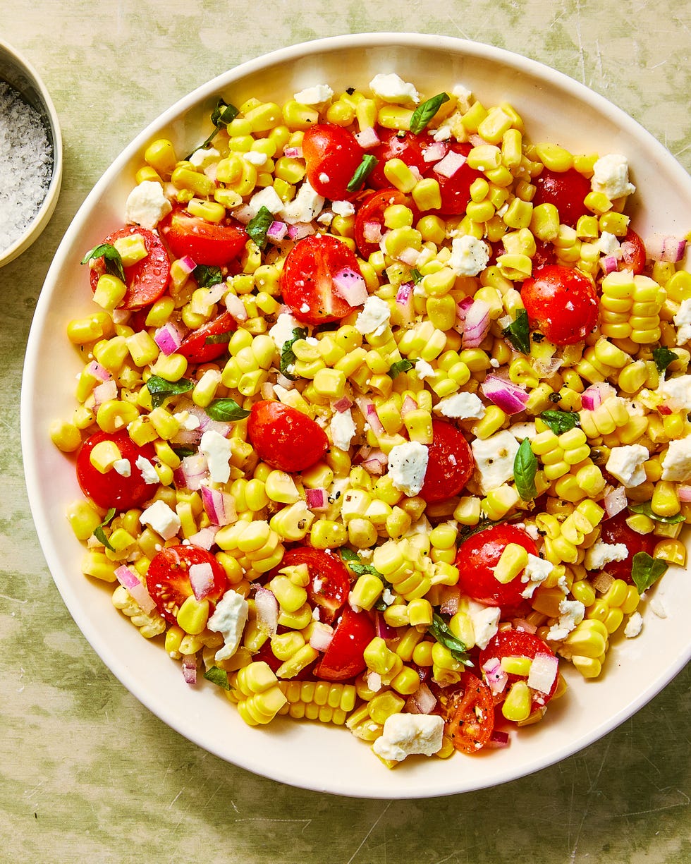corn, chopped tomatoes, feta and basil in a bowl
