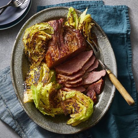 a plate of sliced corned beef with grilled cabbage