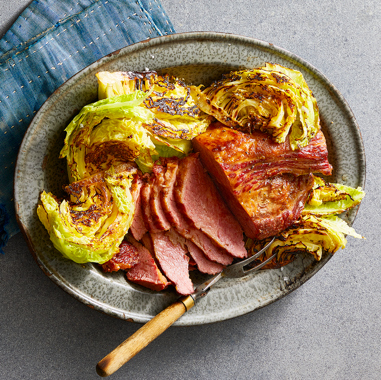 sliced corned beef and grilled cabbage on a gray plate