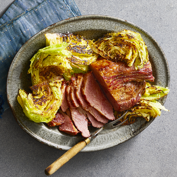 sliced corned beef and grilled cabbage on a gray plate
