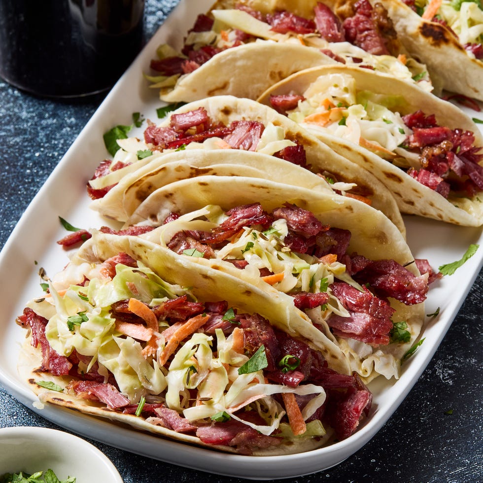 corned beef tacos with green cabbage carrots sauerkraut and beer