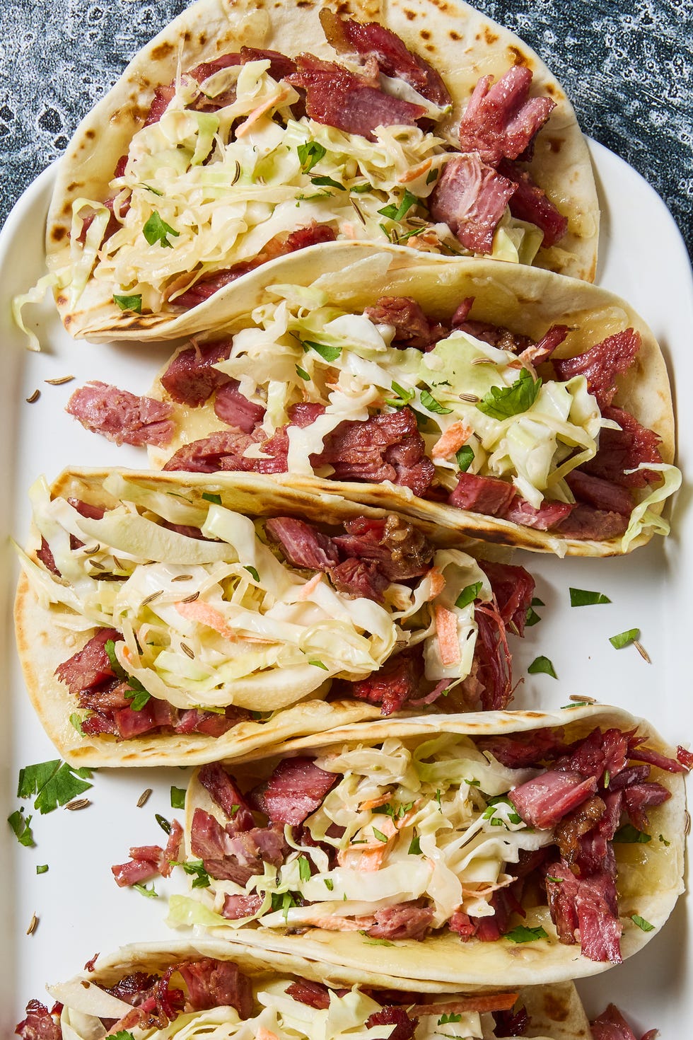 corned beef tacos with green cabbage carrots sauerkraut and beer