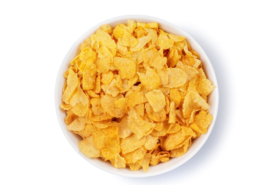 overhead view of a bowl of corn flakes isolated on white