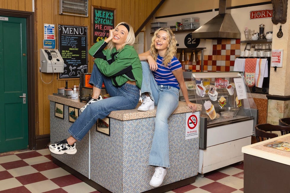 two individuals sitting on a counter in a casual eatery