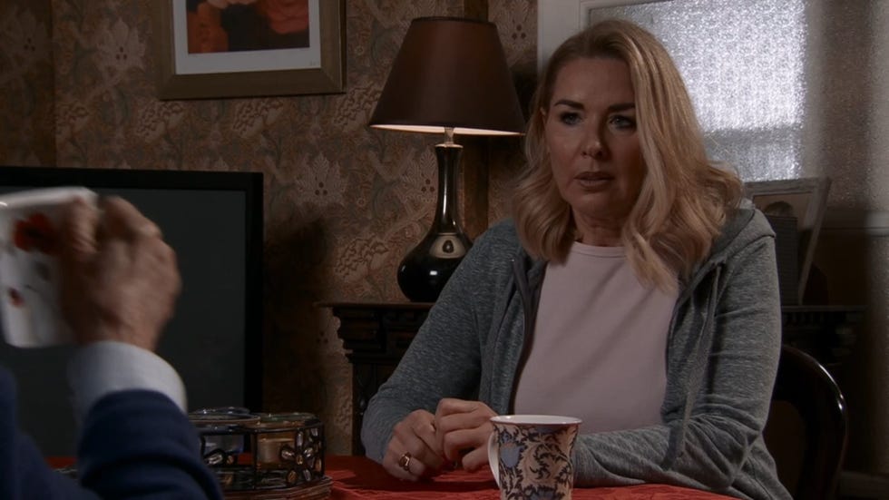 coronation street, cassie plummer sat at the table, looking nervously at a cup of tea