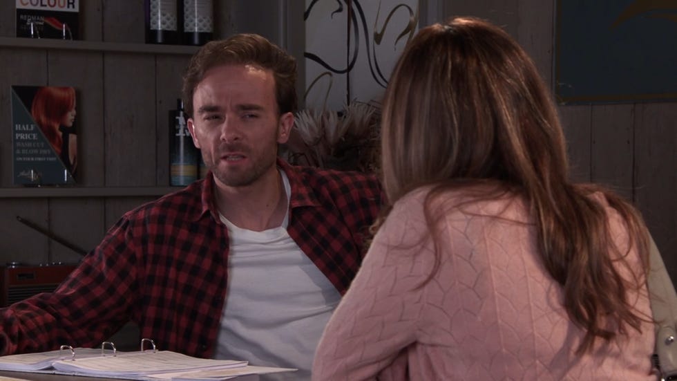 coronation street, david platt in a red chequered shirt giving maria connor a shifty look in the salon