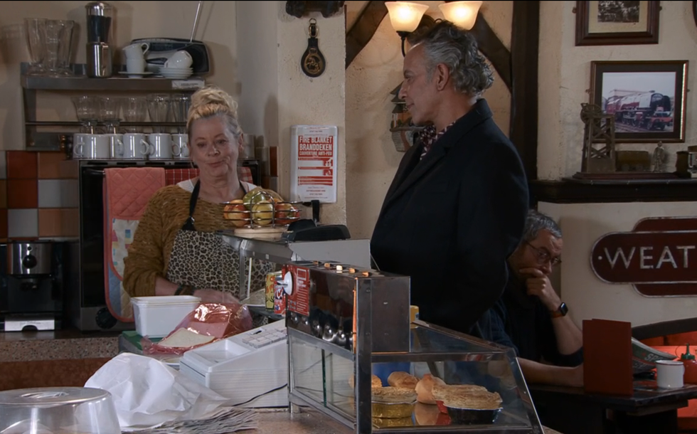 bernie winter and dev alahan having a conversation in the cafe in coronation street