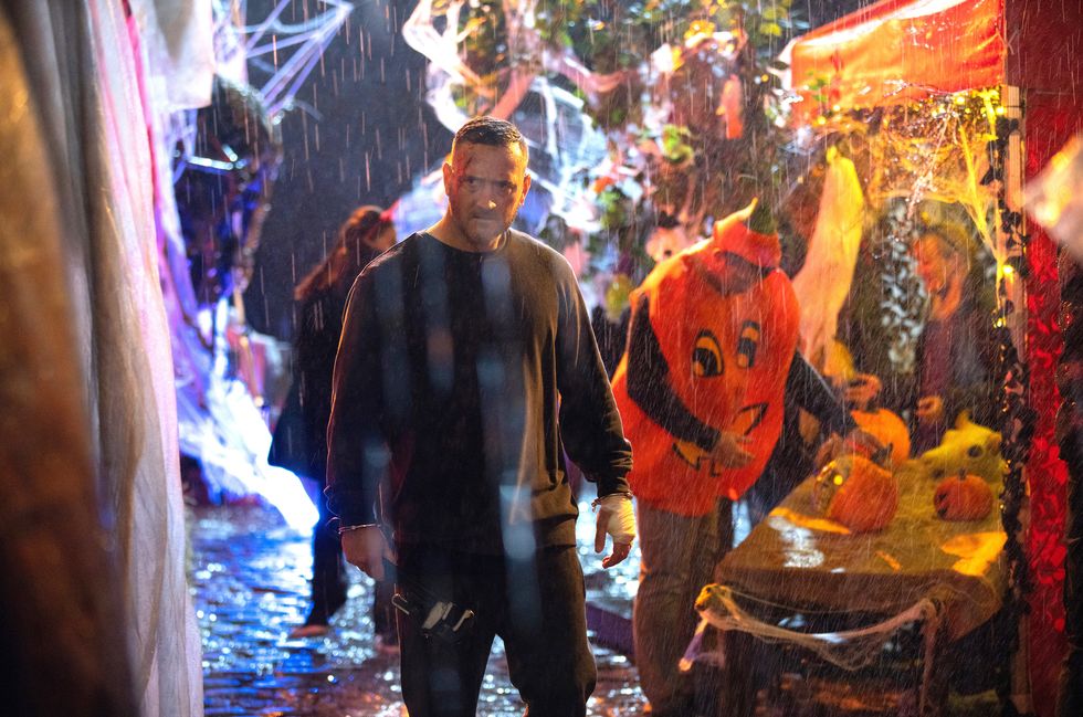 harvey gaskell standing in a halloween market with rain pouring down