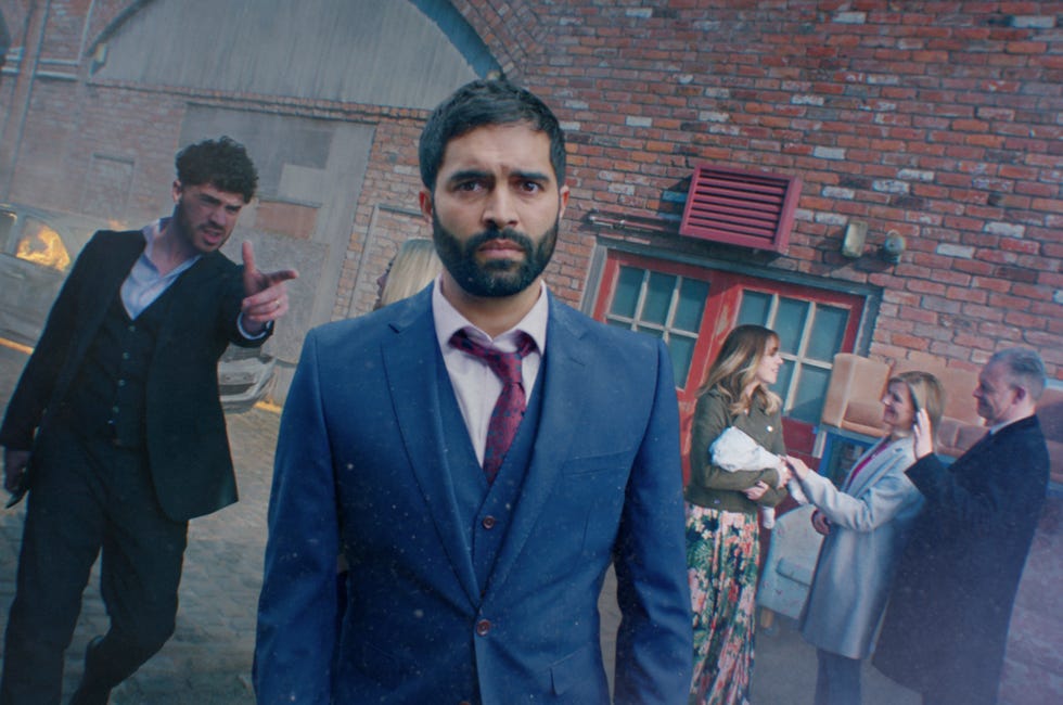 coronation street imran habeeb in may 2022 promo looking at the camera as toyah, adam, nick and leanne are behind him