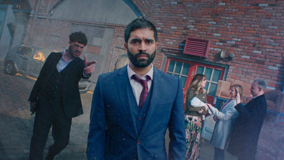 coronation street imran habeeb in may 2022 promo looking at the camera as toyah, adam, nick and leanne are behind him