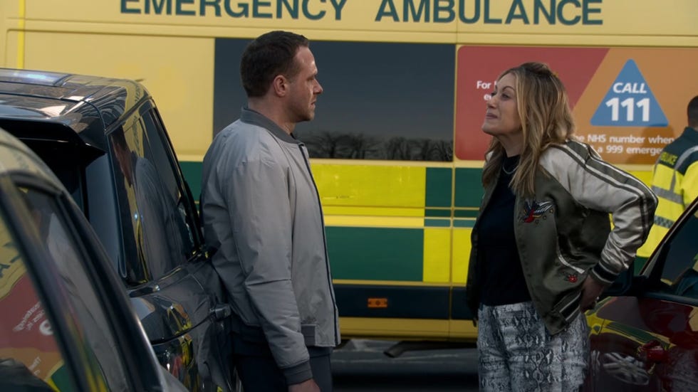 coronation street, mick and lou having an argument outside in front of an ambulance