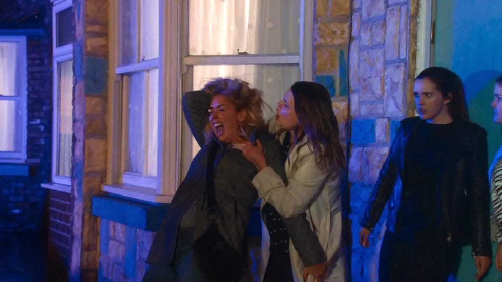 coronation street, tracy barlow attacks cassie plummer in the street, grabbing her by the hair as amy looks on