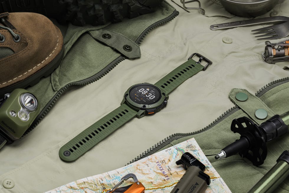 a green outdoor adventure watch lying on a surface