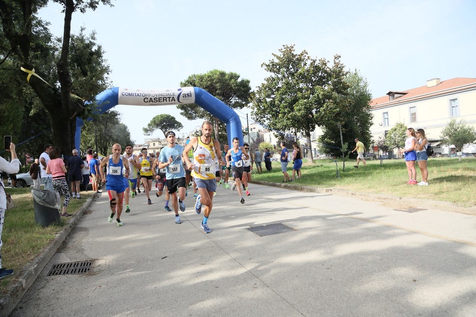 runners participating in a race event in a park setting