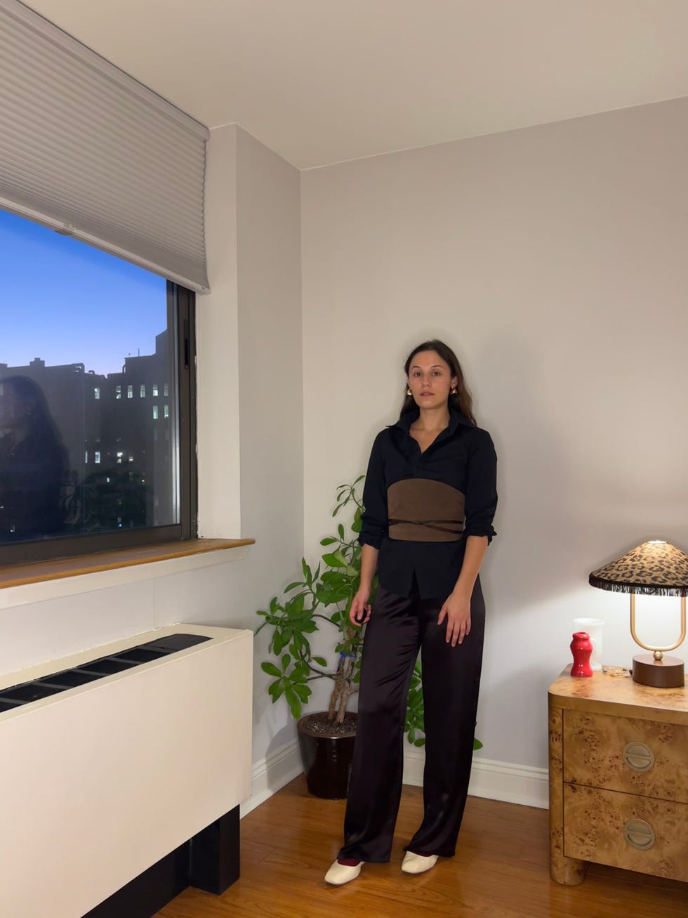 person standing in a welllit indoor space wearing stylish attire