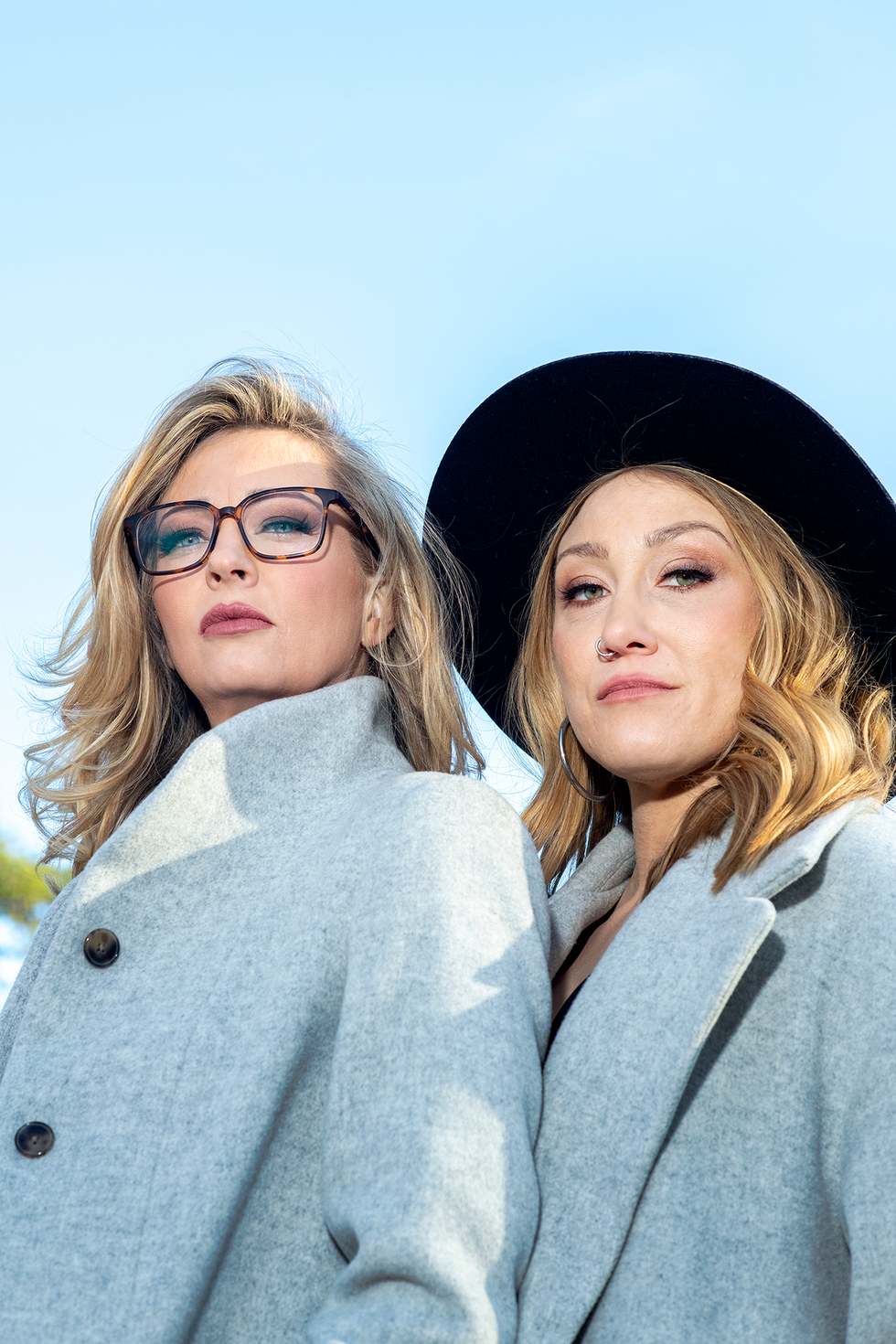 a couple of women posing for the camera