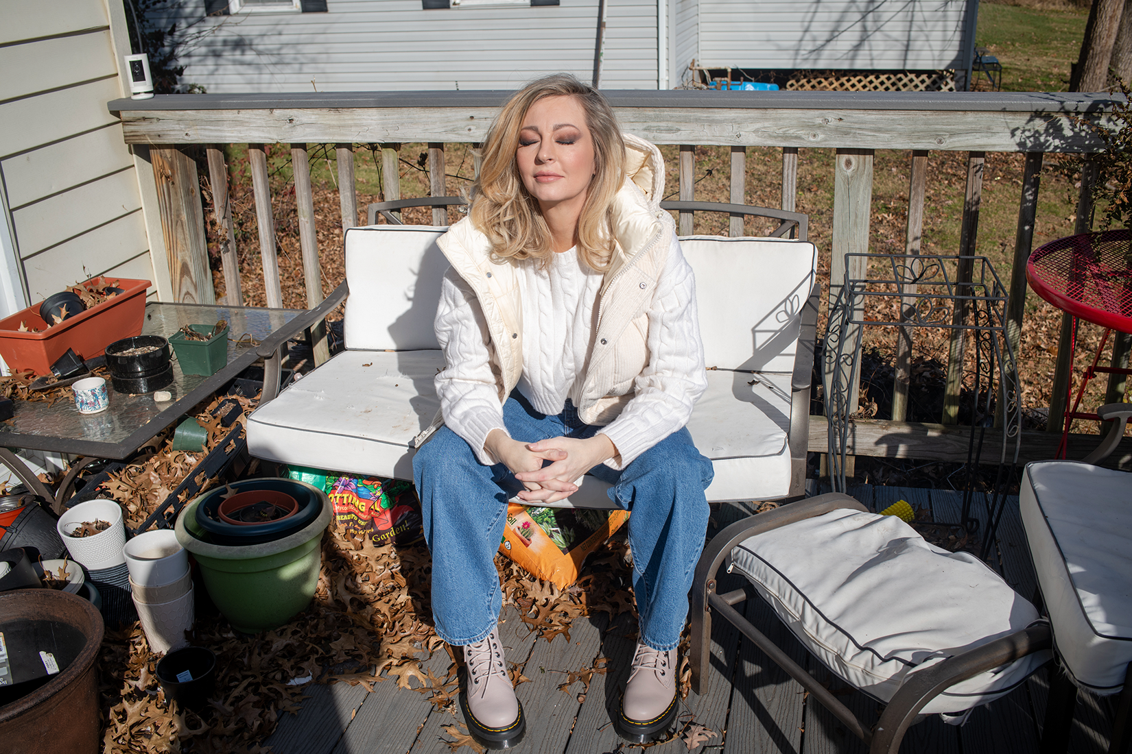 a woman sitting on a chair outside