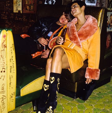 couple cuddling together in a booth