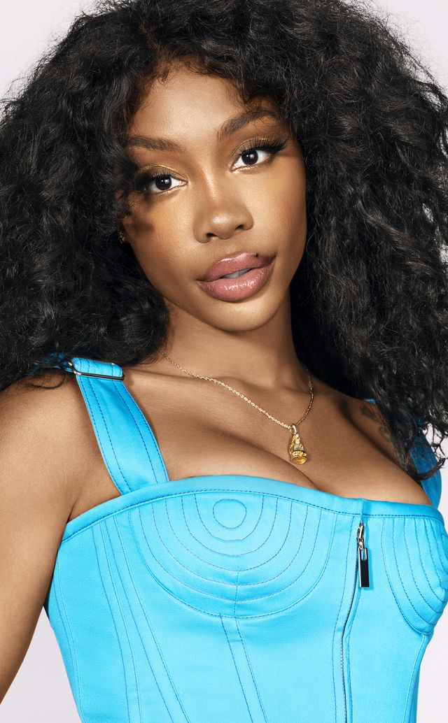 close up of singer sza in a blue outfit