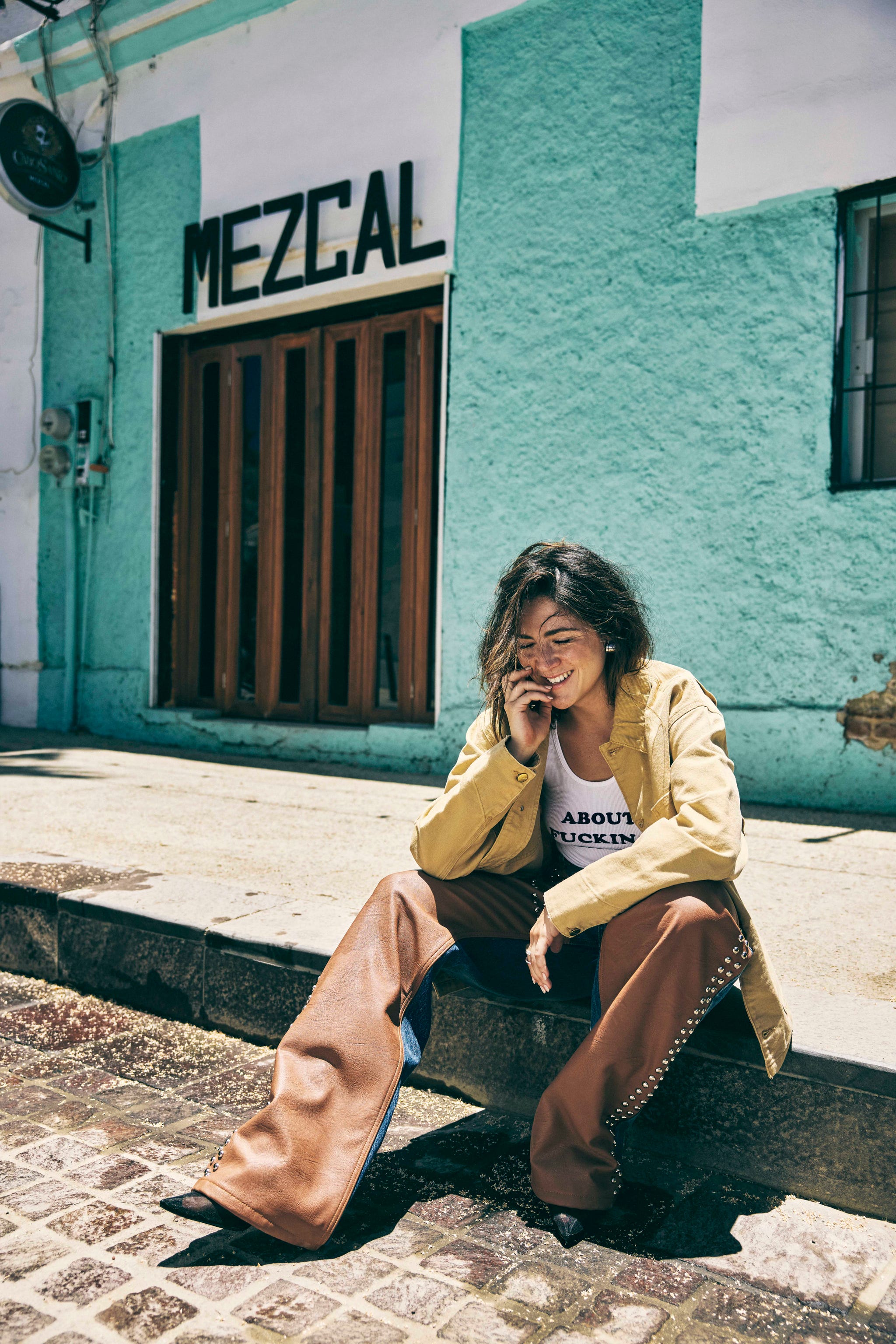 woman in western wear sitting on curb