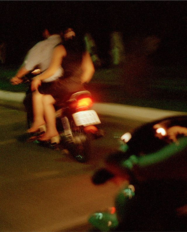 people on the back of a moped