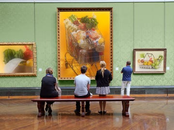 visitors observing grocerythemed artworks in a gallery