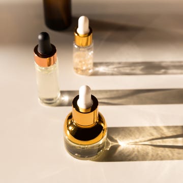 Cosmetic serum bottle with a pipette in harsh light. Harsh shadows. cosmetic serum bottle with a pipette in harsh light harsh shadows