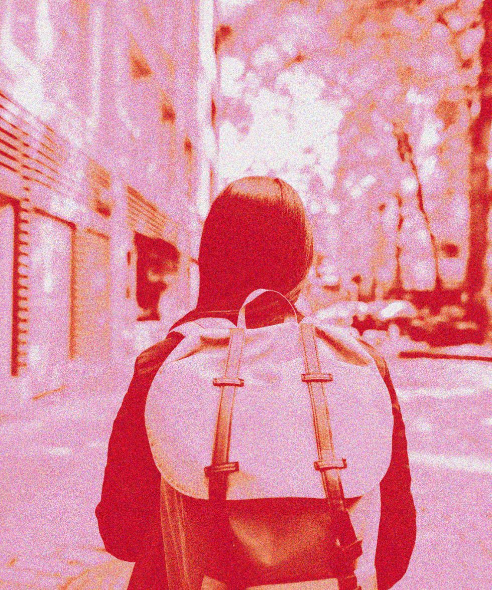 Young woman with backpack on urban street