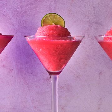 pink frozen cosmo in a glass with a lime circle