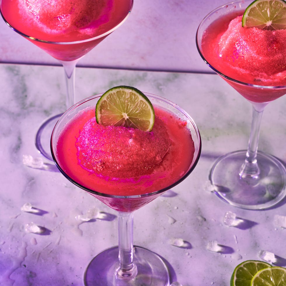 pink frozen cosmo in a glass with a lime circle