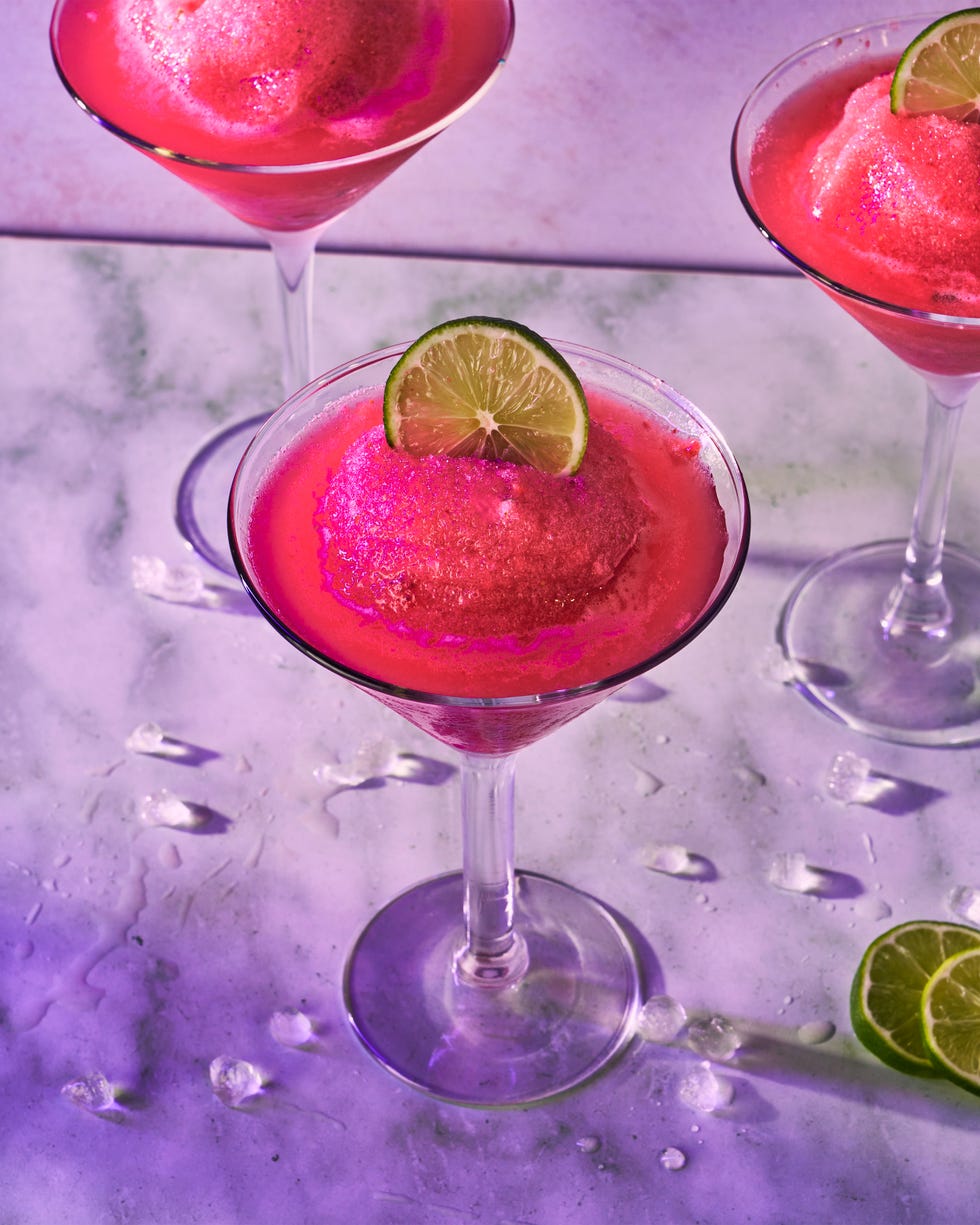pink frozen cosmo in a glass with a lime circle