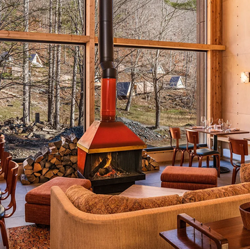 eastwind hotels catskills location lobby featuring a wood burning fire and windows overlooking cabins
