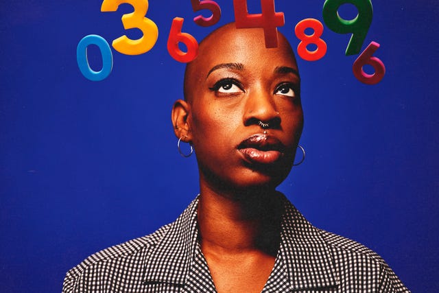 A person against a blue background with colorful numbers floating above