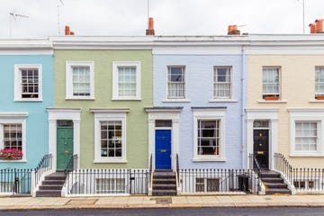 a row of buildings with multi coloured townhouses in notting hill london uk