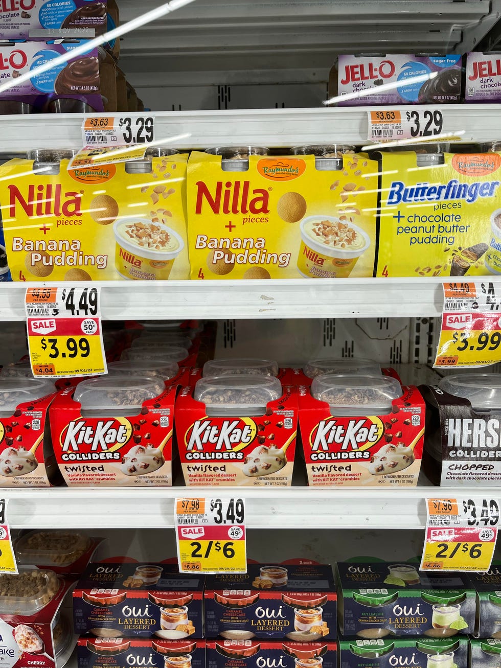 items in grocery store shelf with cost per unit pricing labels shown