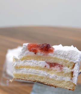 slice of costco strawberry layered cake with cream and fruit filling
