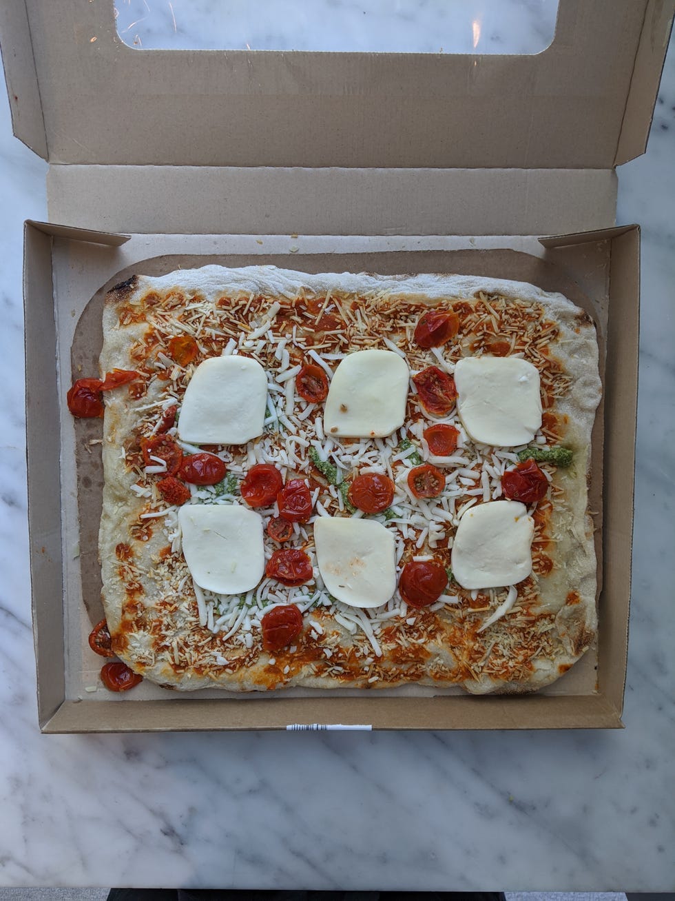 costco take and bake margherita pizza rectangular pizza cut into squares
