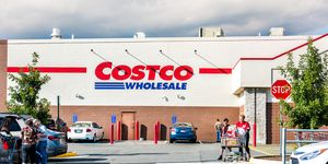 fairfax people with shopping carts filled with groceries goods, products walking out of costco store in virginia in parking car lot