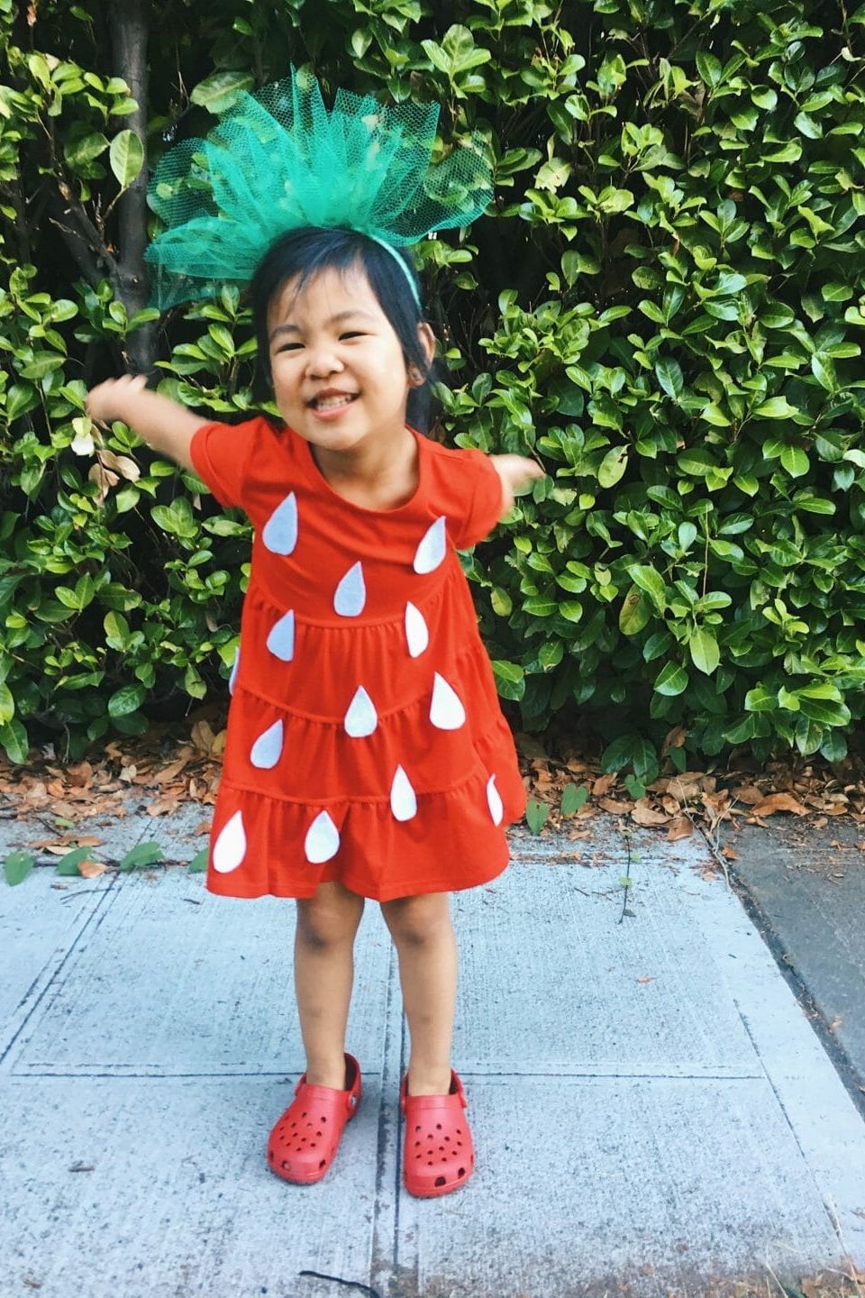 a young girl wears a diy strawberry costume
