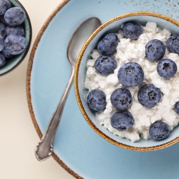 cottage cheese with blueberry, fresh berries, keto healthy breakfast concept, top view.