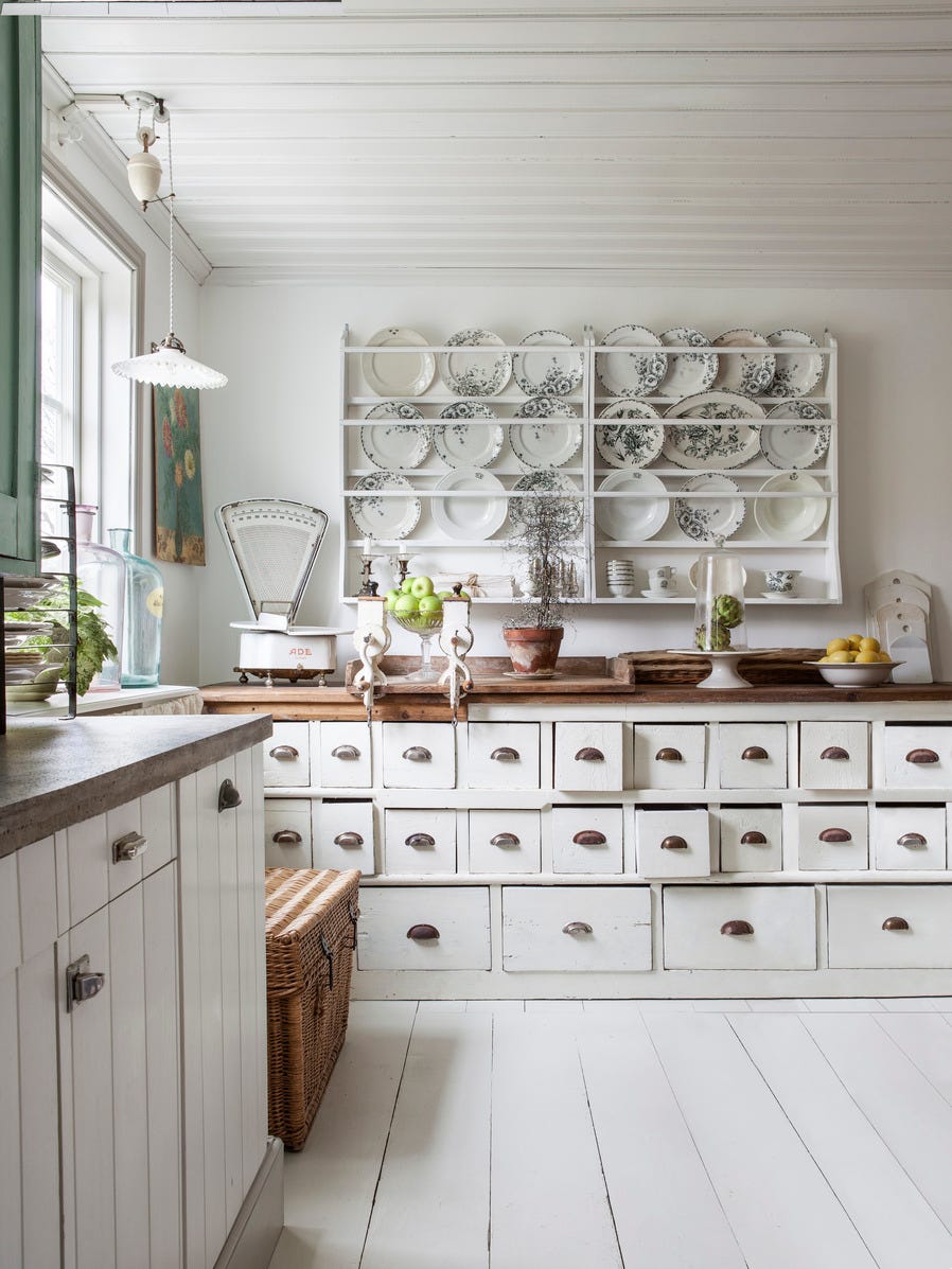 built in cabinetry holding dishes in all white painted home kitchen