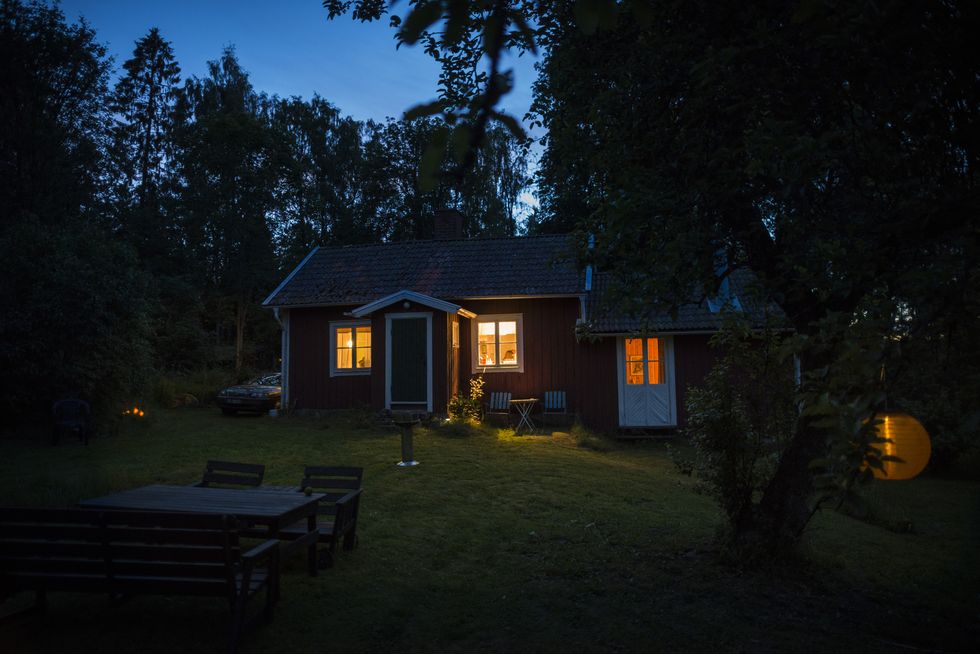 cottage in forest in the evening