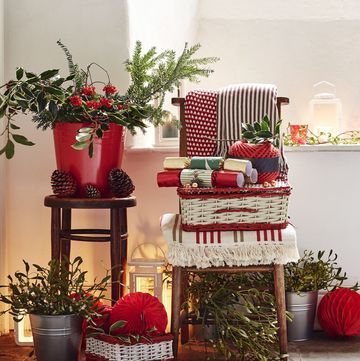 baskets and boxes with christmas tree trimmings and mistletoe in