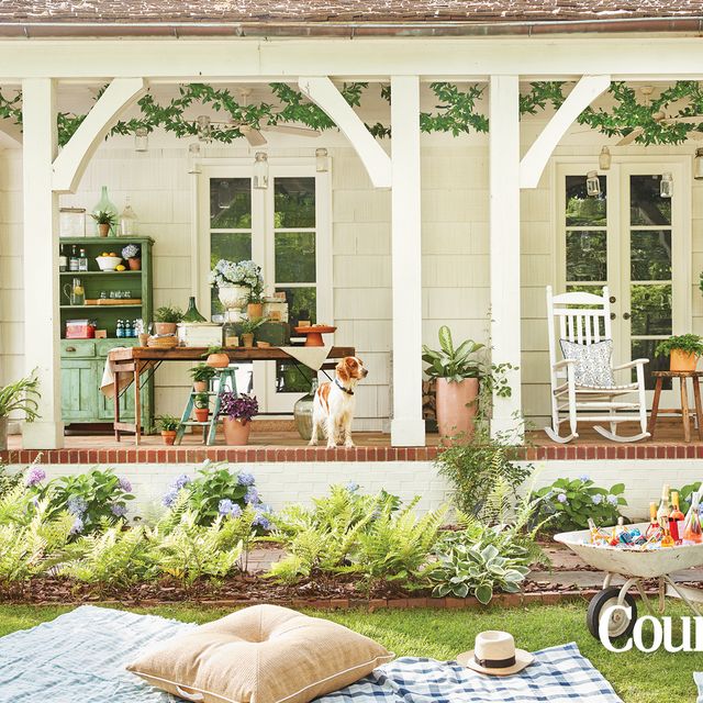 pretty front porch with a dog and rocking chairs