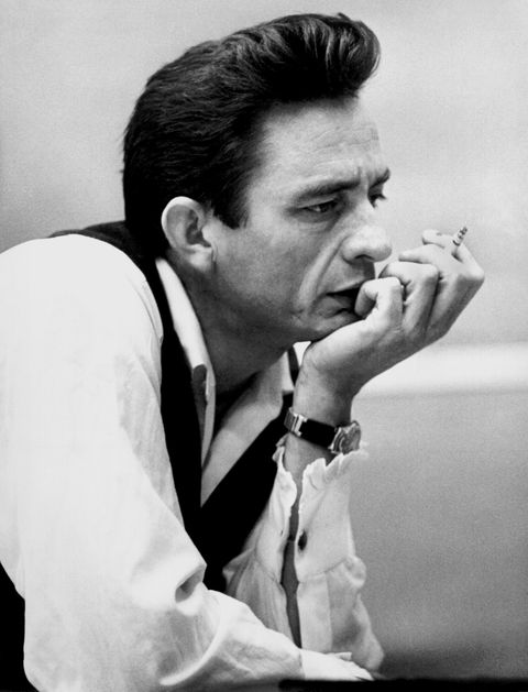 johnny cash smoking a cigarette with his hand on his chin