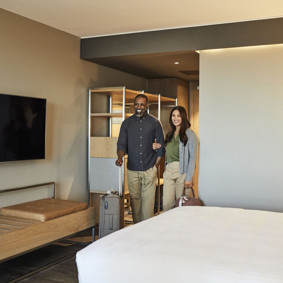couple arriving in hotel room during weekend