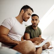 lgbt couple at home using internet and laptop to chat with friends