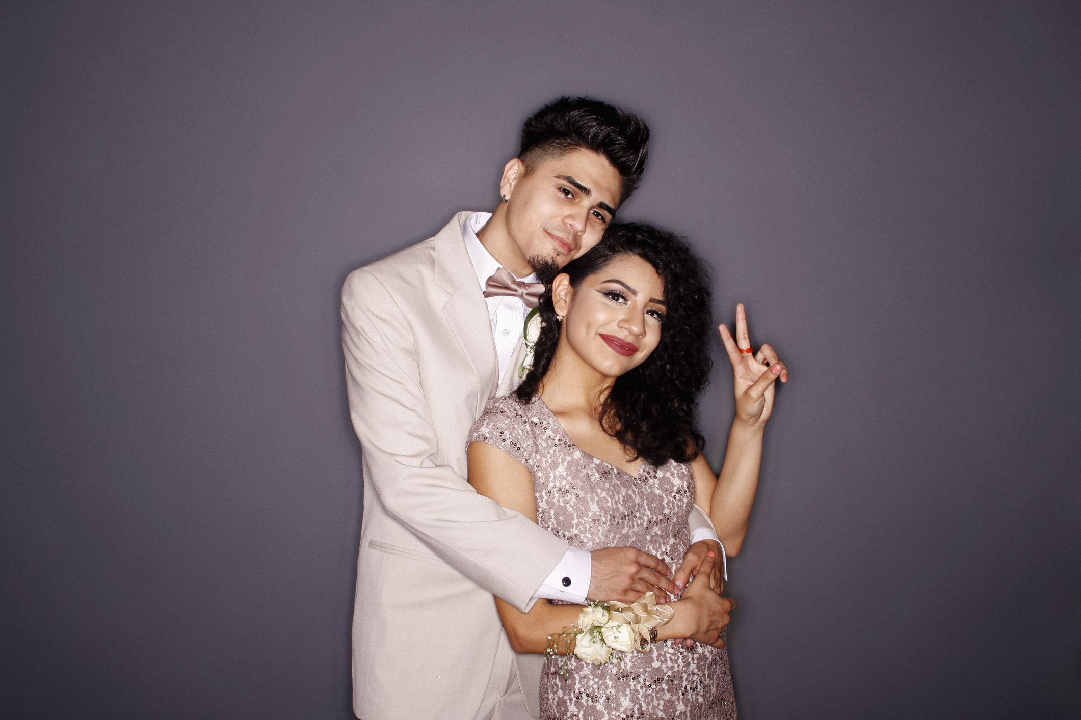 couple at prom giving peace sign royalty free image 1682538507