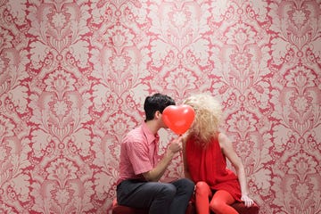 couple behind heart shaped balloon