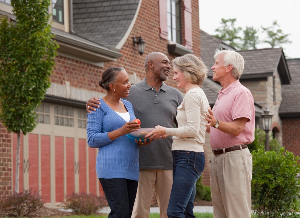 couple bringing food to new neighbors